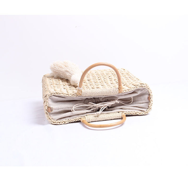Handcrafted straw shoulder bag with decorative tassel pendant Kalsten