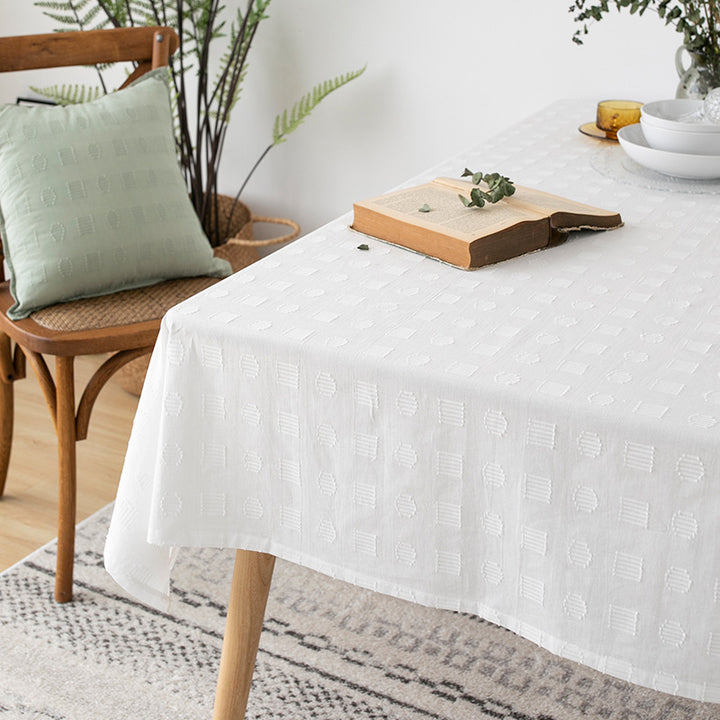Tablecloth made of cotton blend with embossed square and circle relief Kalsten