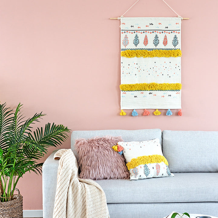 Woven wall hanging with tufted stripes, embroidered leaves, and tassels