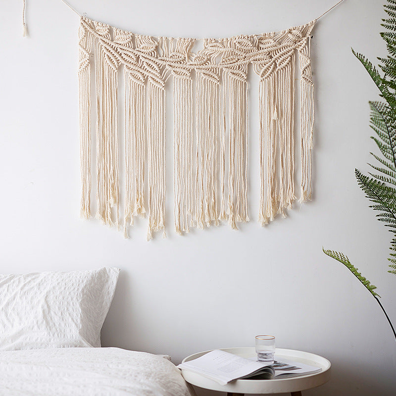 Handmade macrame wall hanging with long tassels and wooden rod