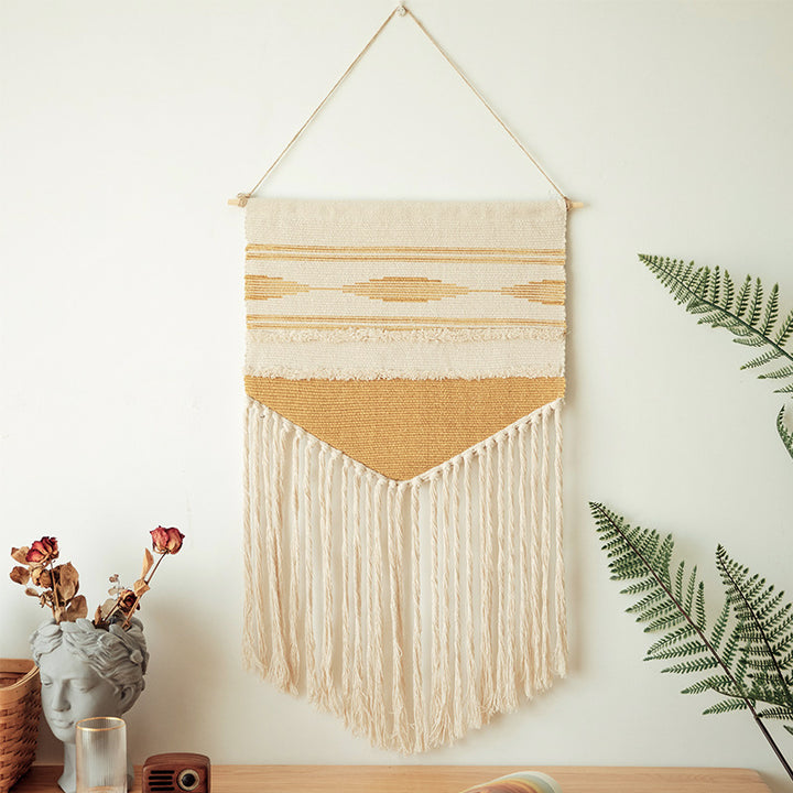 Handwoven wall hanging made of cotton blend with layered textures, wood rod and long fringes Kalsten