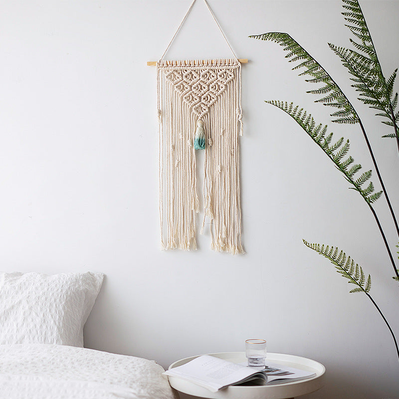 Handmade macrame wall hanging with long tassels and wooden rod
