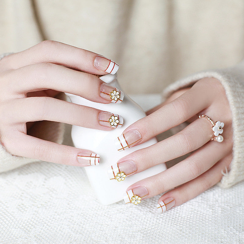 Artificial nails with elegant 3D flower accents and gold trim Kalsten