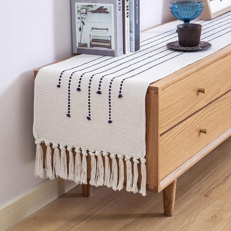 Decorative table runner in Scandinavian-minimalist design with macrame fringes Kalsten
