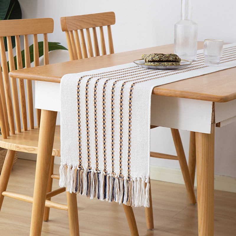 Decorative table runner in Scandinavian-minimalist design with macrame fringes Kalsten