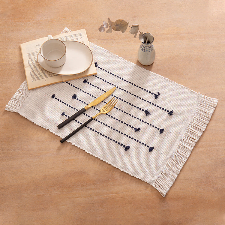 Woven placemats and table runners made of cotton blend with fine dot stripes and knot applications Kalsten