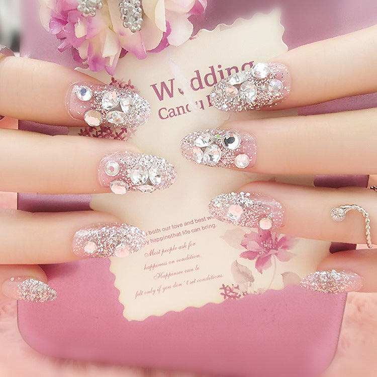 Artificials nails with sparkling rhinestone accents and elegant flower embellishments Kalsten