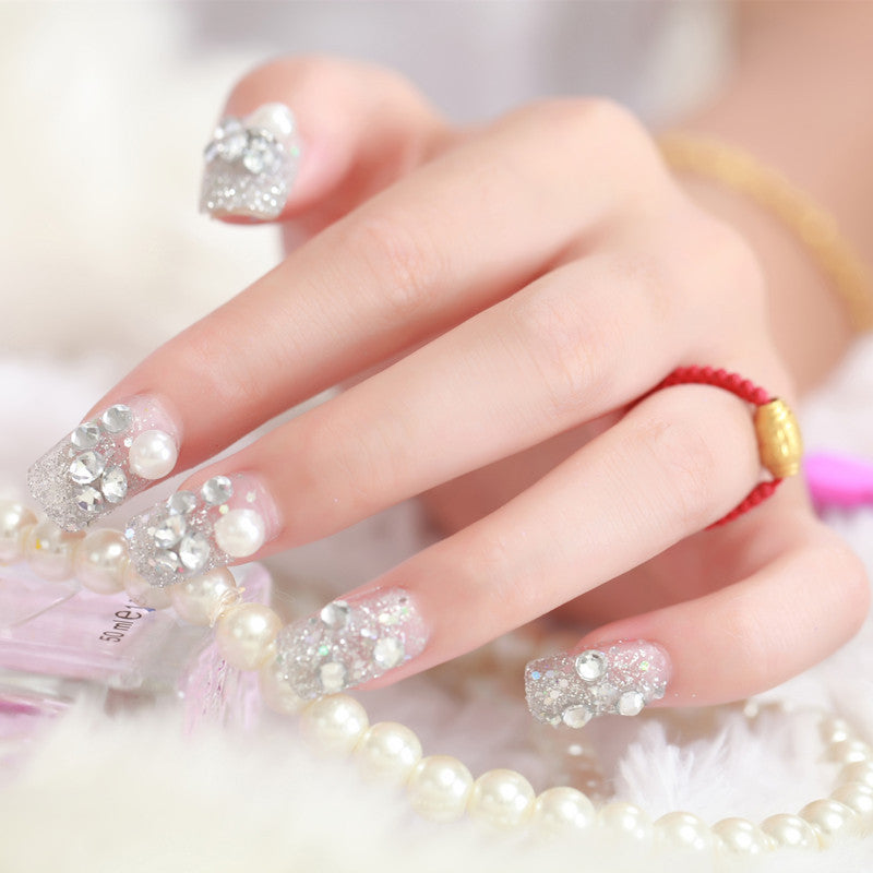 Art nails with glitter and pearl accents Kalsten