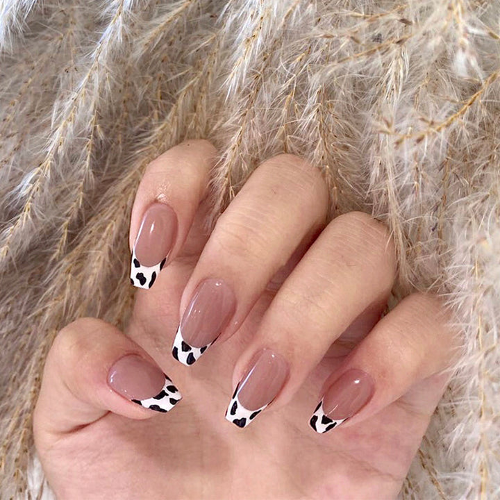 Stylish nail extensions in modern cow print style Kalsten