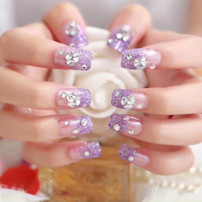 Artificials nails with sparkling rhinestone accents and elegant flower embellishments Kalsten