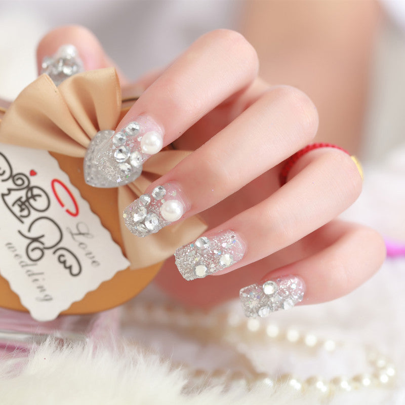 Art nails with glitter and pearl accents Kalsten