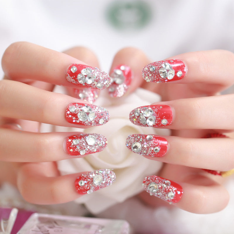 Artificials nails with sparkling rhinestone accents and elegant flower embellishments Kalsten