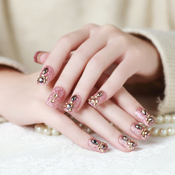 Glamorous artificial nails with glitter and jewelry decoration Kalsten