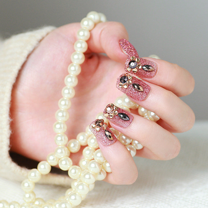 Glamorous artificial nails with glitter and jewelry decoration Kalsten