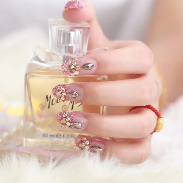 Glamorous artificial nails with glitter and floral elements Kalsten