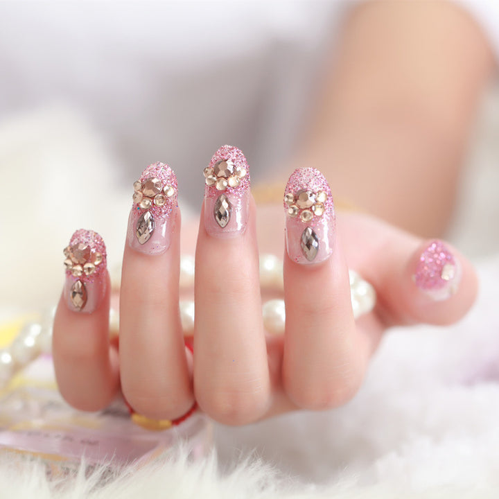 Glamorous artificial nails with glitter and floral elements Kalsten