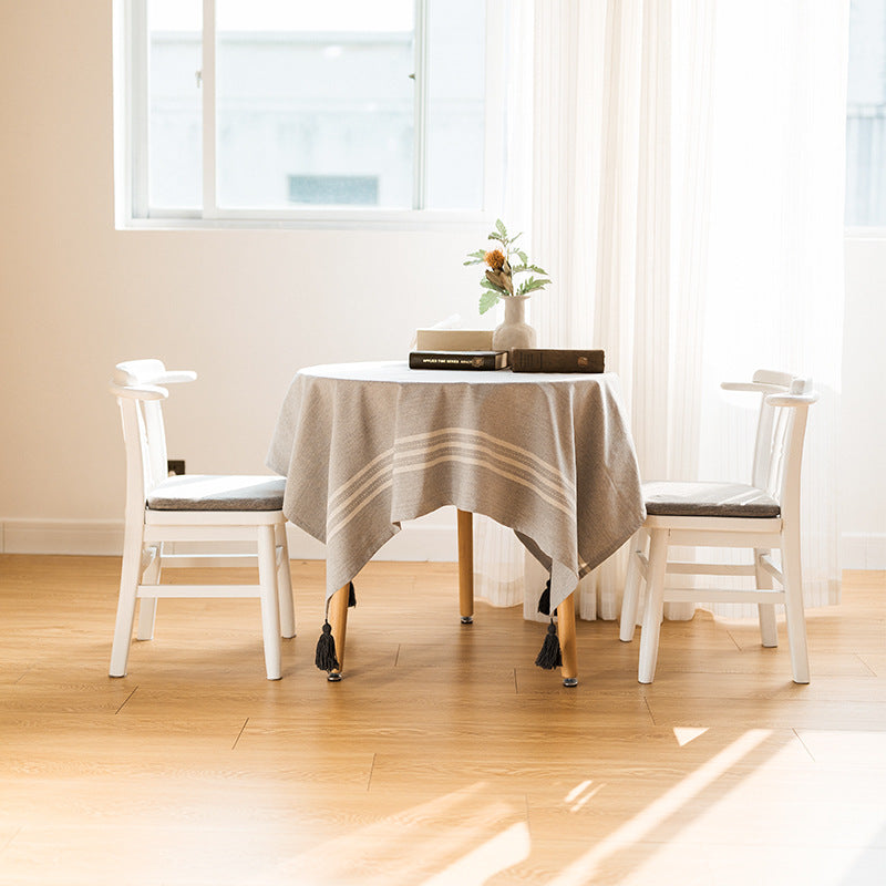 Rectangular linen look tablecloth with fringed tassels and side stripe border design Kalsten