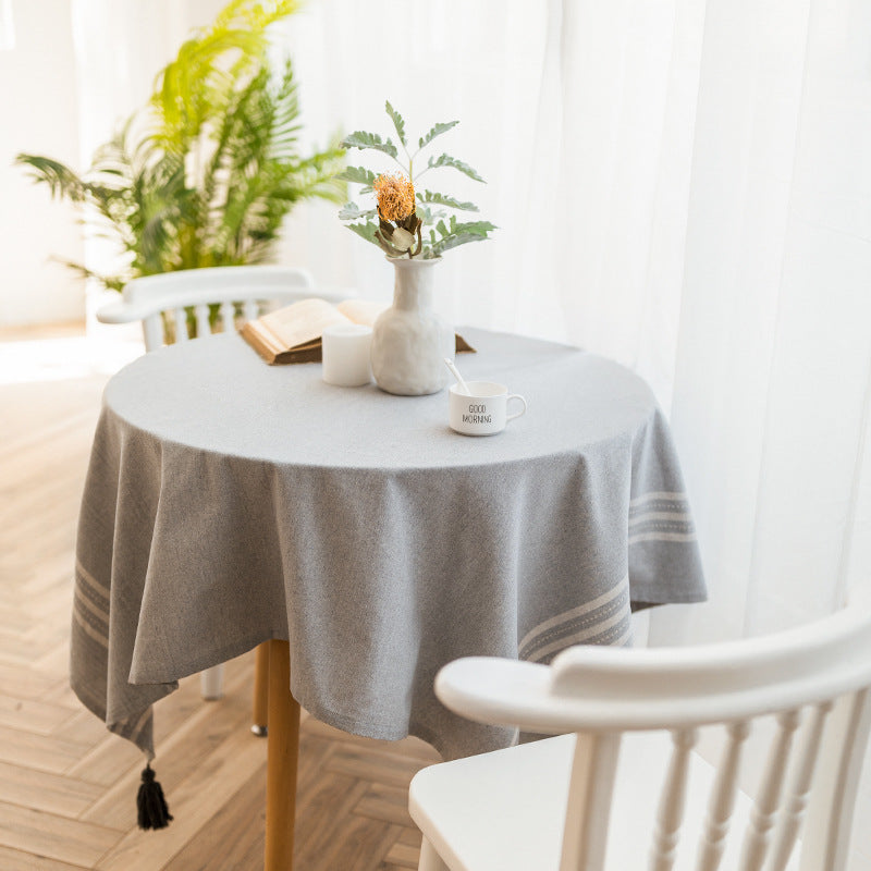 Rectangular linen look tablecloth with fringed tassels and side stripe border design Kalsten