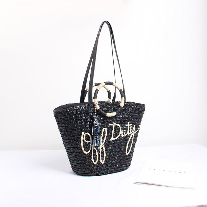 Designer shoulder bag with playful lettering and decorative tassel detail Kalsten