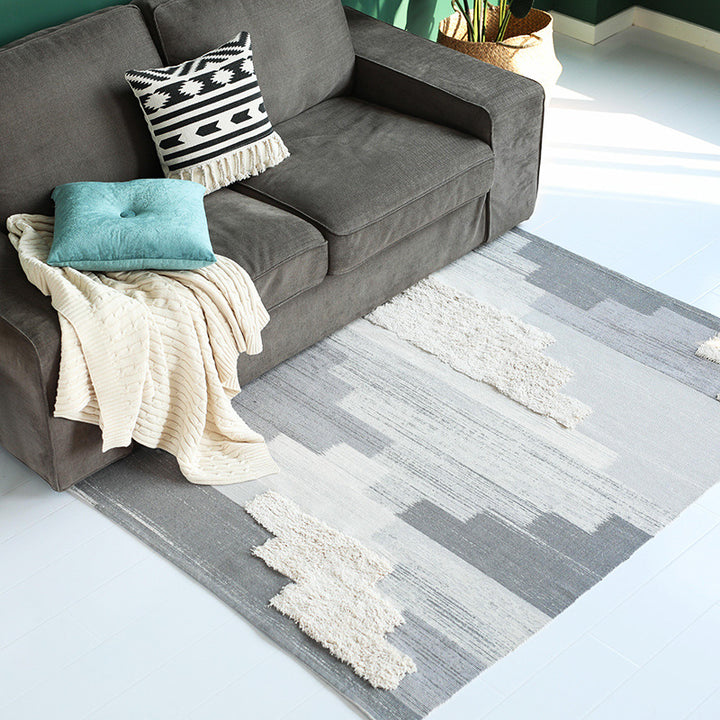 Modern woven living room rug with abstract structure and tufted high-pile accents Kalsten