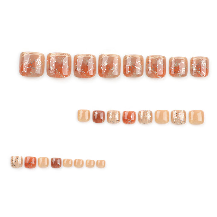 Artistic toenail design with glitter and golden accents Kalsten