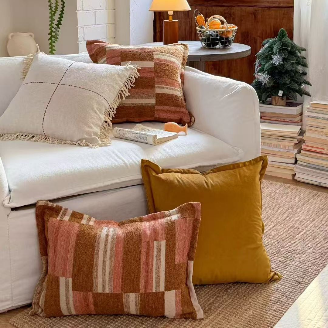 Decorative cushion made of linen look with hand-tied fringes and cross-stitch detail