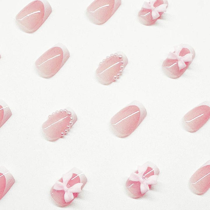 Artificial nails with elegant bows and pearl embellishments Kalsten