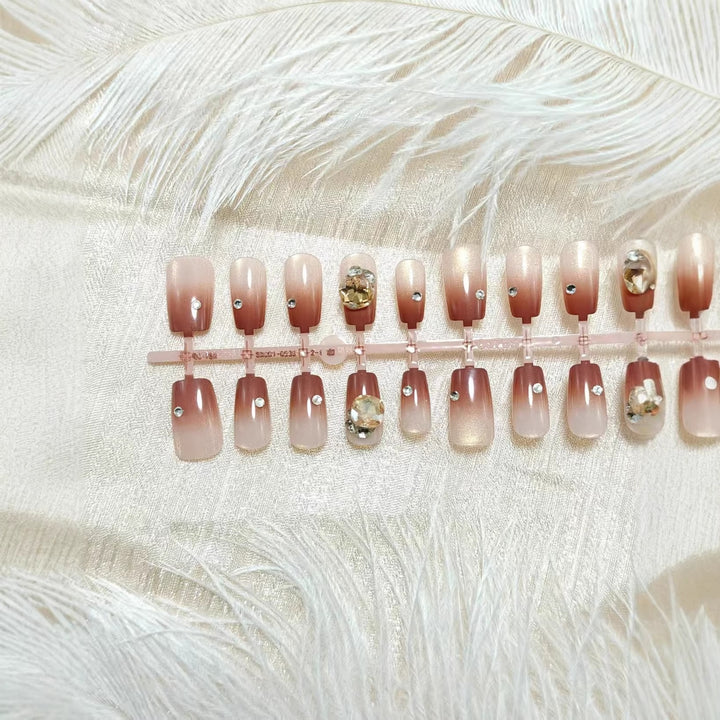 Artificials nails in elegant ombre style with rhinestone embellished applications Kalsten