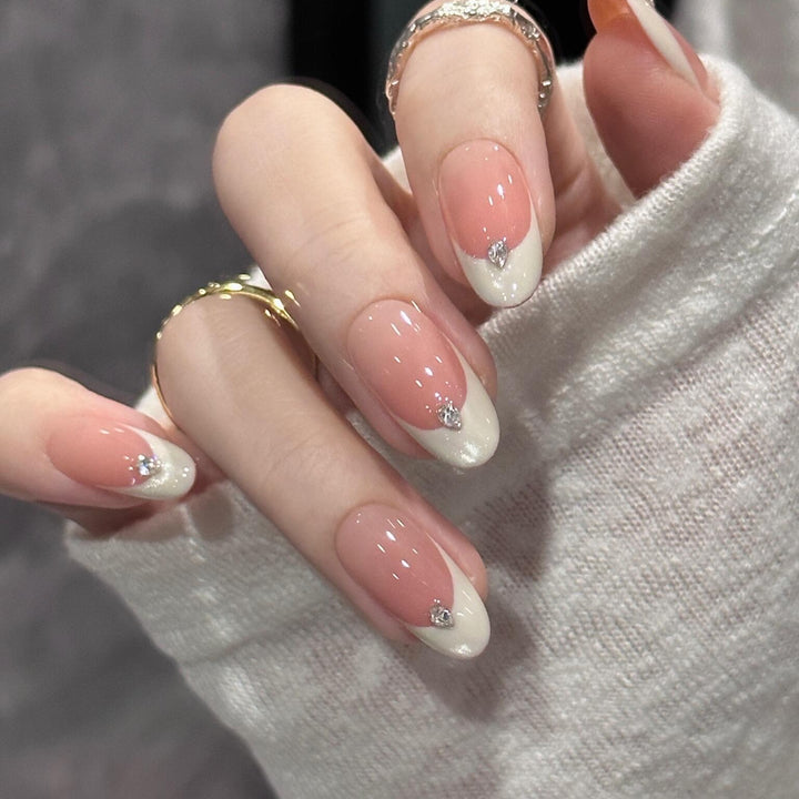 Artificial nails with elegant French style and sparkling accents Kalsten