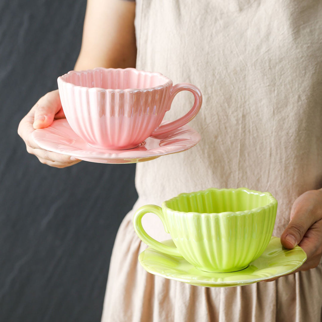 Fine porcelain tea cup with ribbed shell shape and matching saucer