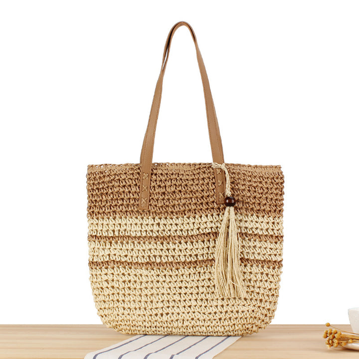 Handbag made of braided natural material with decorative tassel pendant Kalsten