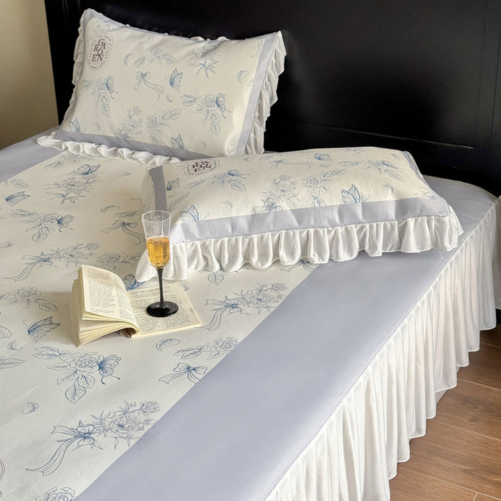 Bedding set with ruffled bed skirt, floral printed center piece and frill pillow