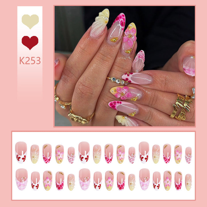 Artificial nails with floral accents and glitter decorations Kalsten