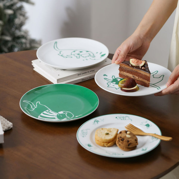 Decorative ceramic plate with cat motif and green border decoration