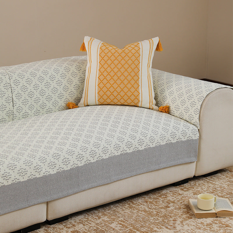 Knitted sofa cover with jacquard pattern and reinforced hem border Kalsten