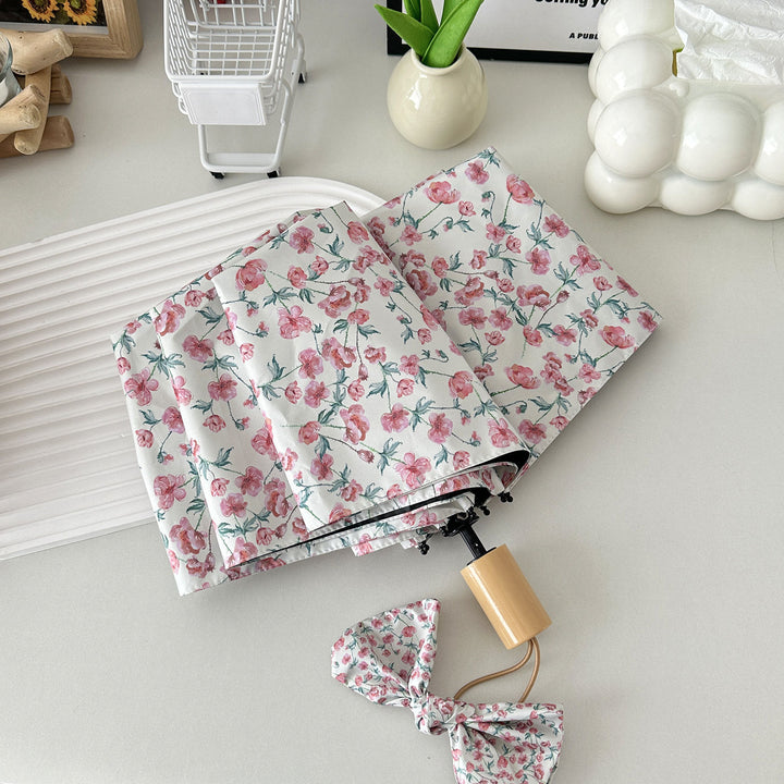 Women's folding umbrella with floral design and practical storage system Kalsten