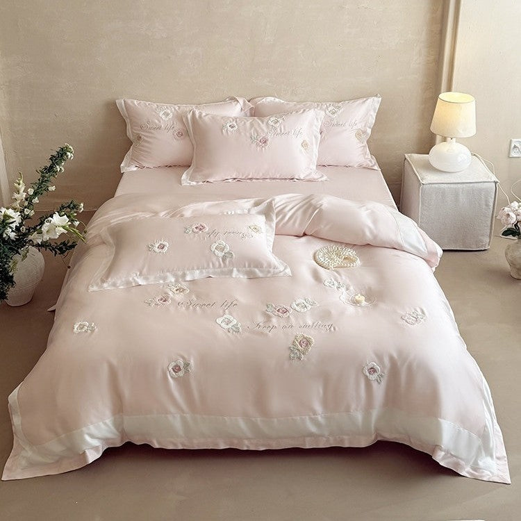 Luxurious satin bedding set with embroidered rose appliqués and silky glossy finish