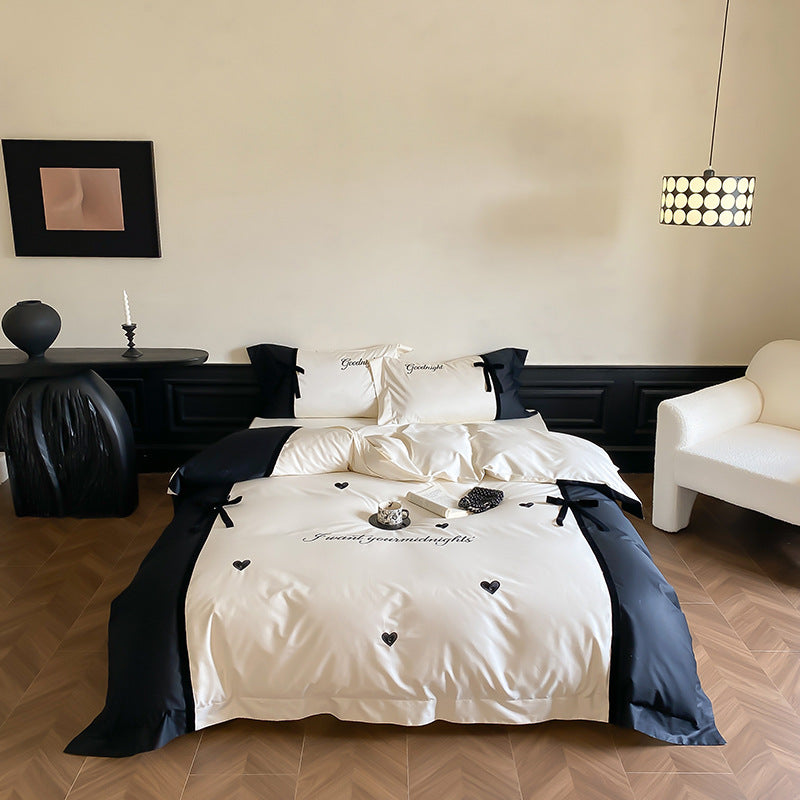 Reversible satin bedding set with bow appliqué and embroidered lettering