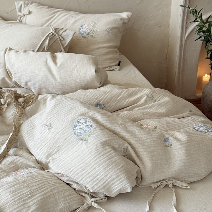 Embroidered cotton-linen bedding set with decorative ribbons and fine floral design