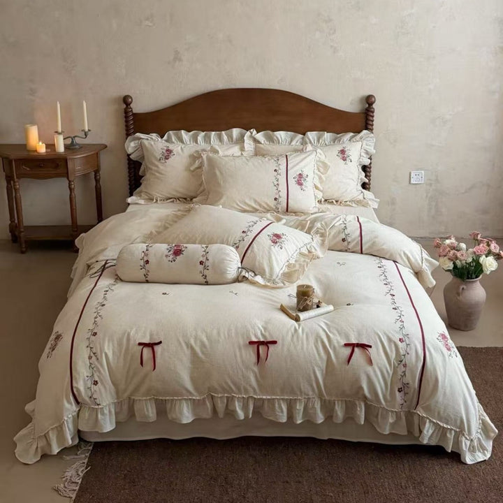 Natural fiber duvet cover set with delicate floral hand embroidery, linen look, and decorative ruffle
