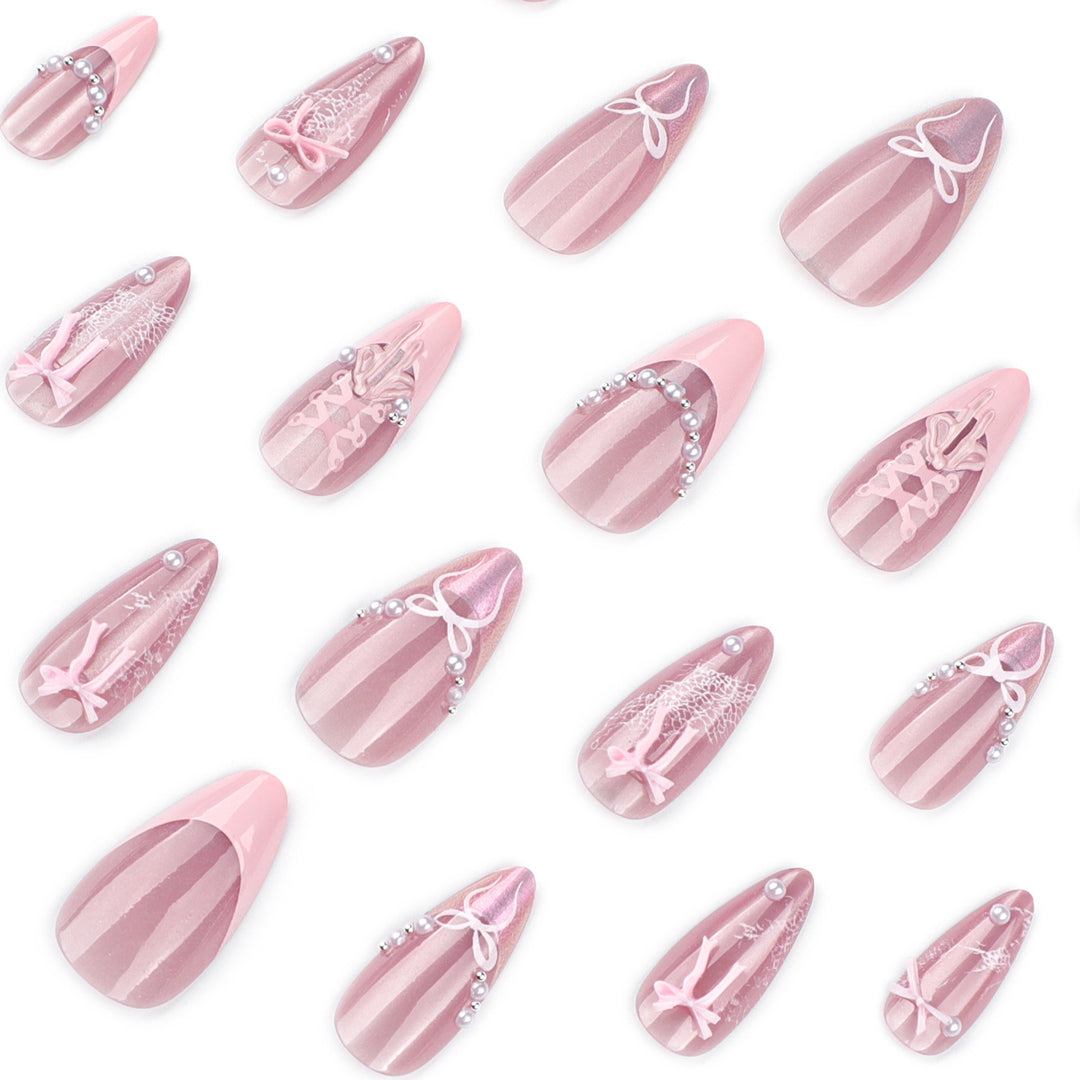 Artful nail extensions with delicate bow motifs Kalsten