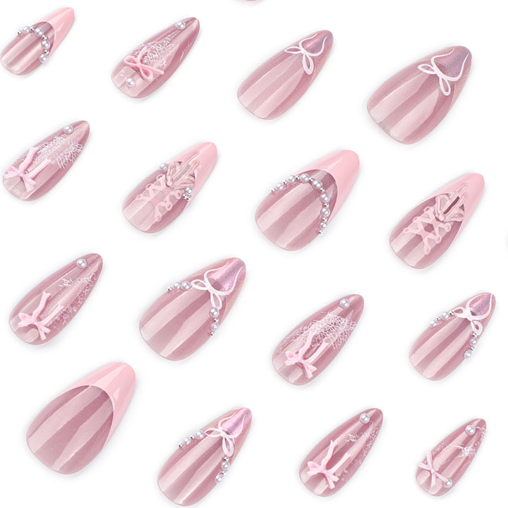 Artful nail extensions with delicate bow motifs Kalsten
