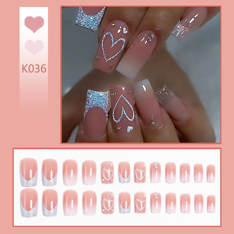 Artificial nails with sparkling heart designs and glitter details Kalsten
