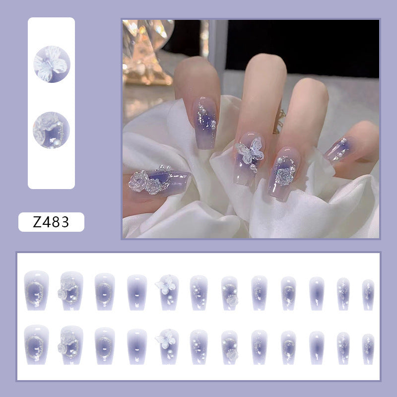 Artistic acrylic nails with butterfly design and glitter accents Kalsten