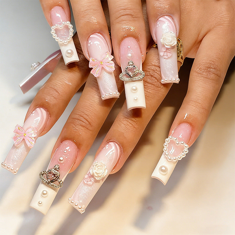 Artful nail tips with pearl and bow motifs Kalsten