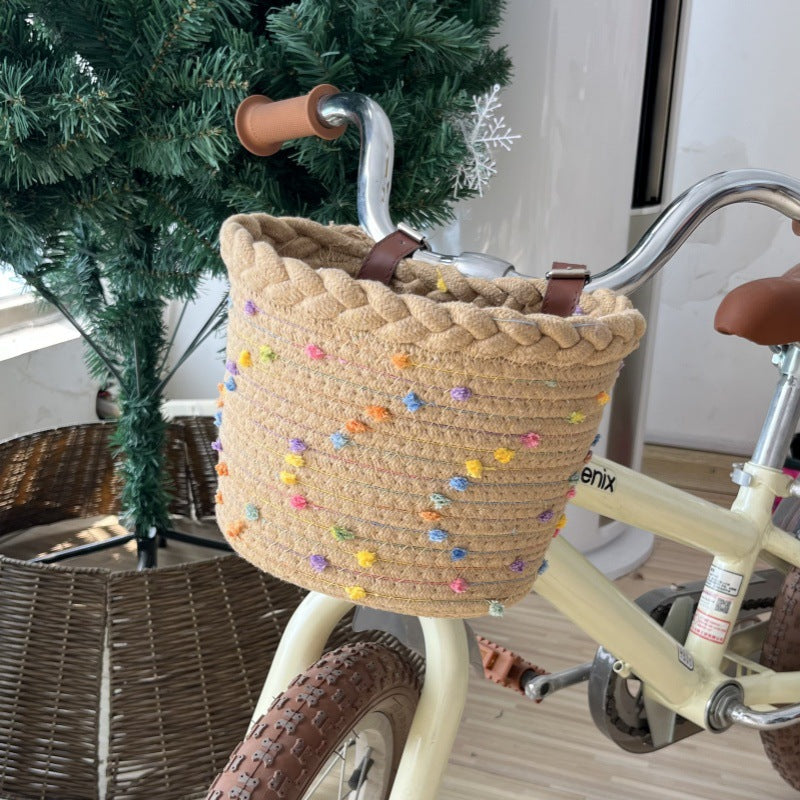 braided rope bike basket with pom pom embellishments and leather handlebar straps Kalsten