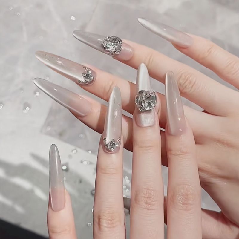 Acrylic nail set with elegant tips and glamorous rhinestone accents Kalsten