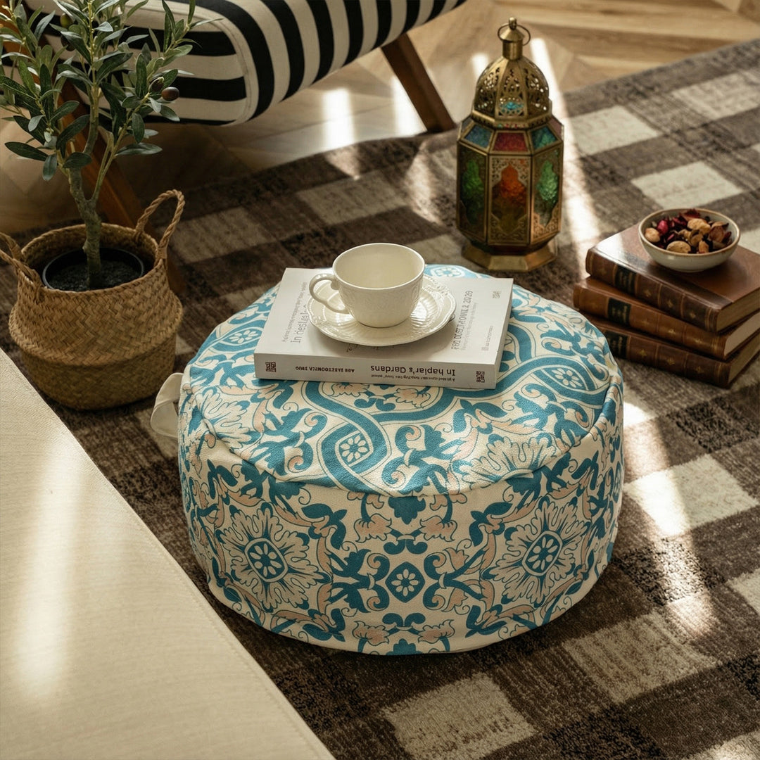 Round floor pouf with woven ornament pattern and carrying handle Kalsten