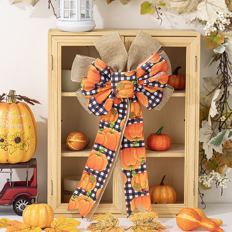 Large autumn door bow made of jute with pumpkin print and gingham ribbons