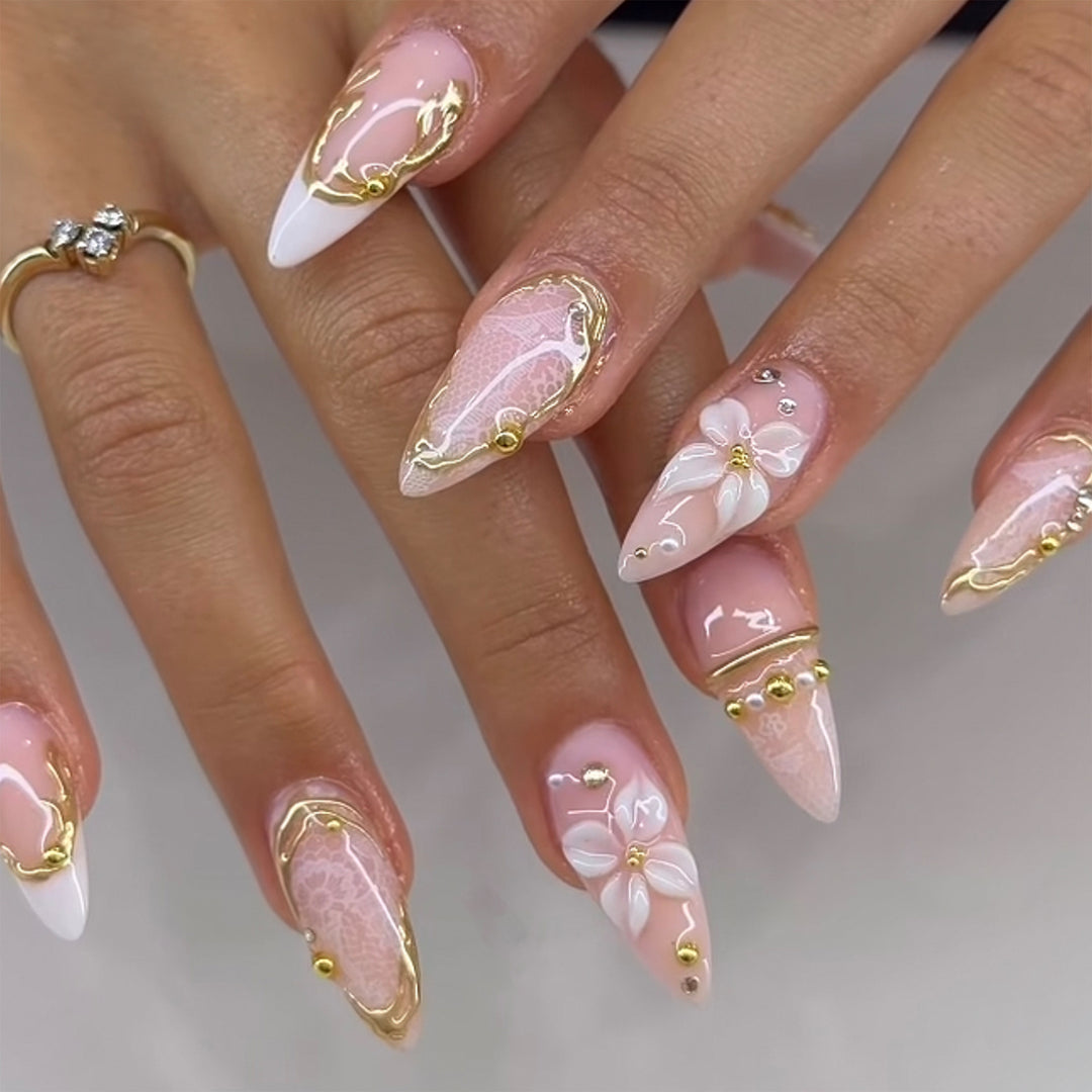 Artful nail extensions with delicate flower and gold embellishments Kalsten